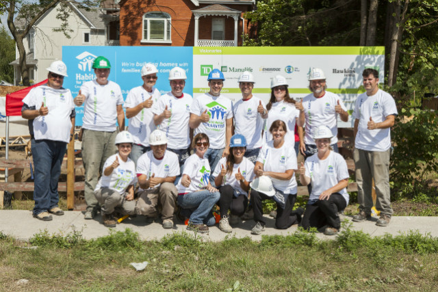 Whitchurch-Stouffville Mayor Justin Altmann (centre blue hard hat)built alongside Geranium team on Friday.